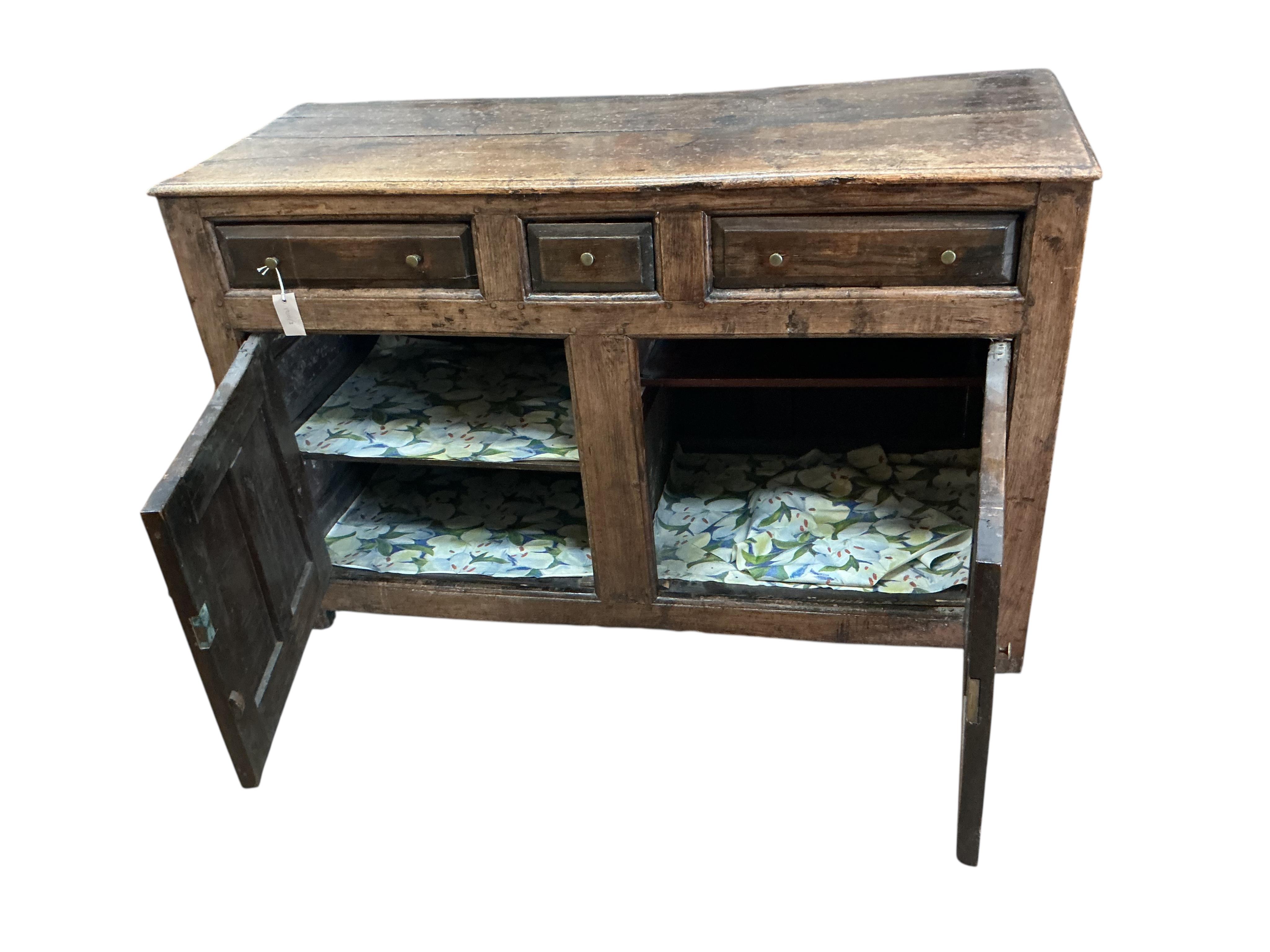 A mid 18th century North Wales oak enclosed dresser base, width 134cm, depth 52cm, height 85cm